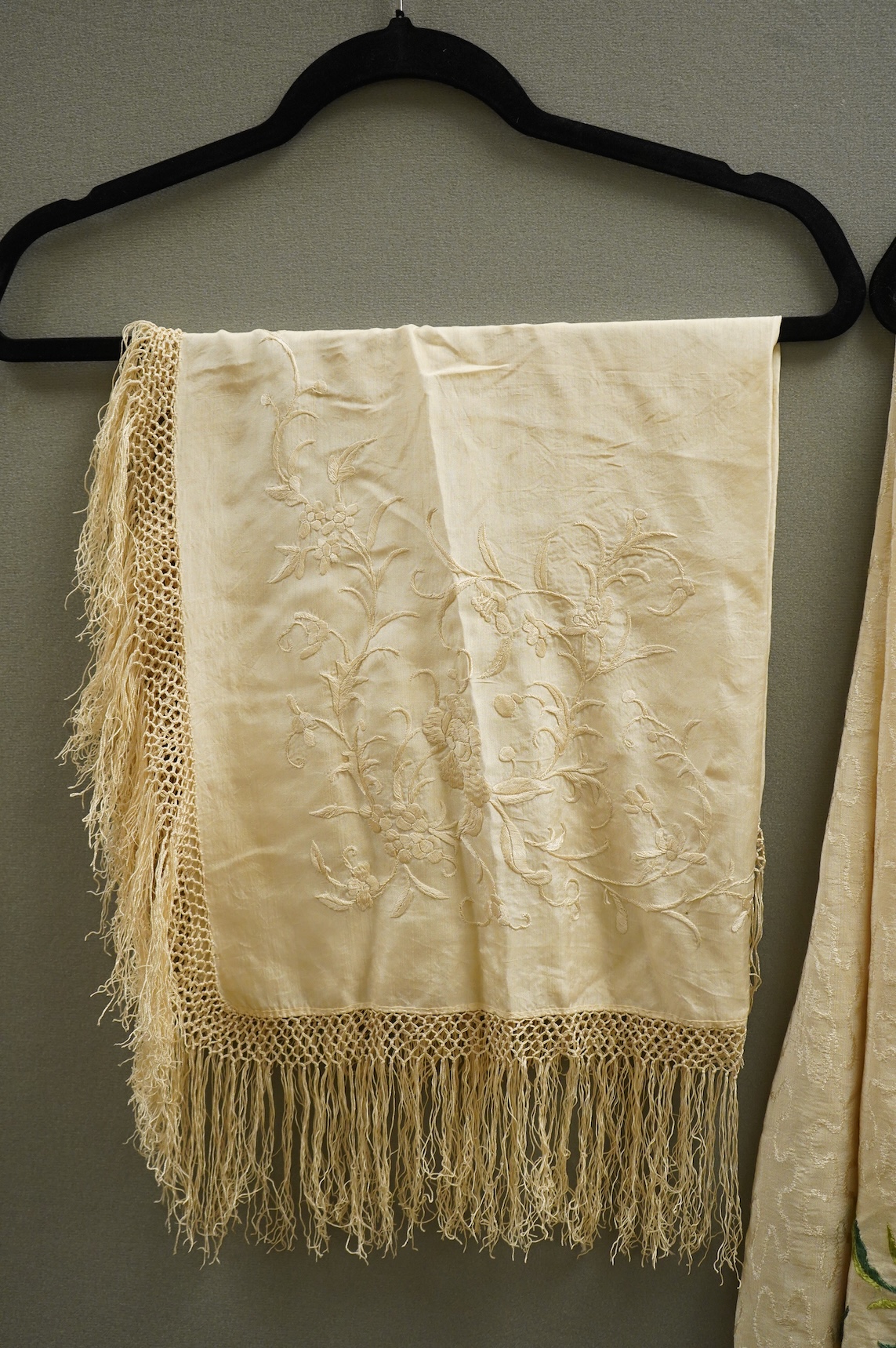 An early Chinese 20th century cream silk damask shawl with a polychrome floral silk embroidered border and a silk fringe, 150cm x 150cm, together with a smaller shawl/scarf, the corner cream on cream embroidered and edgi